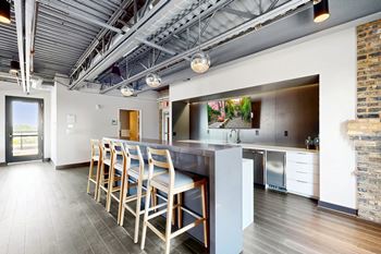 A kitchen with a dining table and chairs.